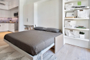 Диван-кровать-шкаф трансформер экономит пространство и позволяет совместить гостиную и спальню в небольших квартирах. Стенка и шкафы выполнены из крашенного МДФ