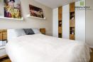 Мебель для спальни: кровать, шкаф, открытые полки и тумбочки выполнены из ДСП Egger