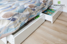 Кровать в детскую комнату с мягкими панелями у изголовья выполнена из крашенного МДФ.